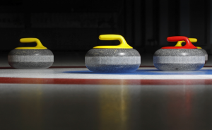 Three Curling Rocks on the Ice